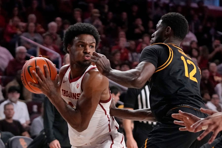 Southern California guard Bronny James, left, tries to get by Long Beach State guard Jadon Jones during the first half of an NCAA college basketball game Sunday, Dec. 10, 2023, in Los Angeles. (AP Photo/Mark J. Terrill)