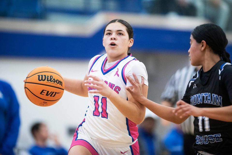 Atwater sophomore Natalia Melgoza (11), left, attempts to dribble past Mountain House freshman Surianti Bakri (11), right, during a CIF Sac-Joaquin Section Division 2 playoff game at Atwater High School in Atwater, Calif., on Wednesday, Feb. 14, 2024. The Falcons beat the Mustangs 95-59.