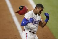 Texas Rangers' Andy Ibanez shakes his left hand after being hit by a pitch thrown by Los Angeles Angels starter Chris Rodriguez in the second inning of a baseball game in Arlington, Texas, Monday, Aug. 2, 2021. Ibanez continued playing in the game. (AP Photo/Tony Gutierrez)