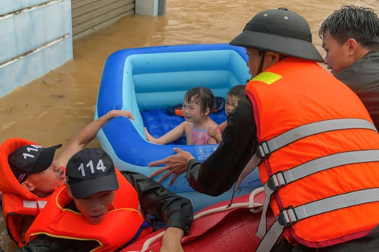 Rescuers help children escape flood waters in Vietnam's northern Ha Giang province on June 10 (Trong Hai)