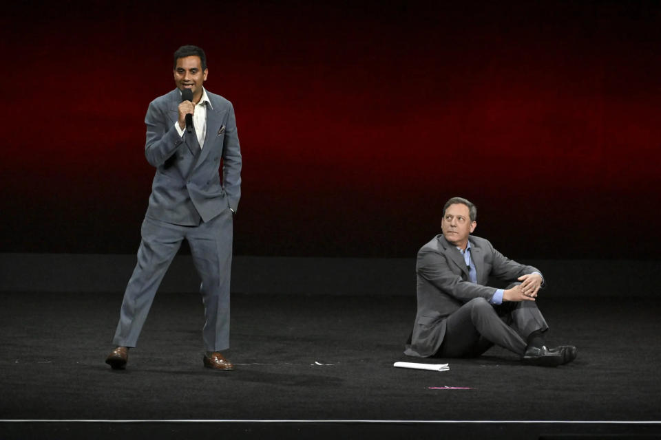 aziz ansari on stage with adam fogelson at cinemacon