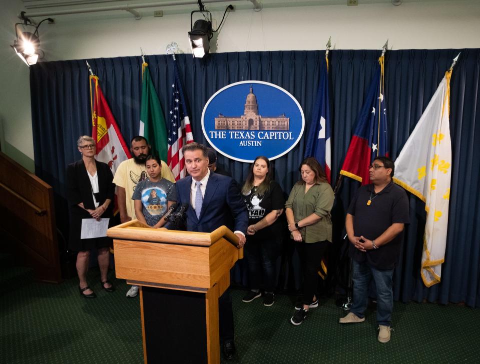 Sen. Roland Gutierrez, standing with the families of Robb Elementary School shooting victims, discusses several gun safety proposals during a news conference at the Capitol on March 7.