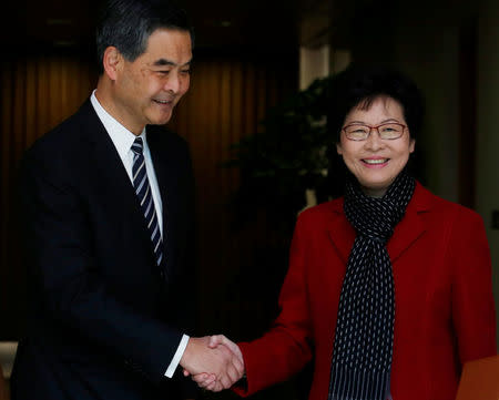 Newly elected Chief Executive Carrie Lam (R) meets current leader Leung Chun-ying in Hong Kong, China March 27, 2017. REUTERS/Bobby Yip