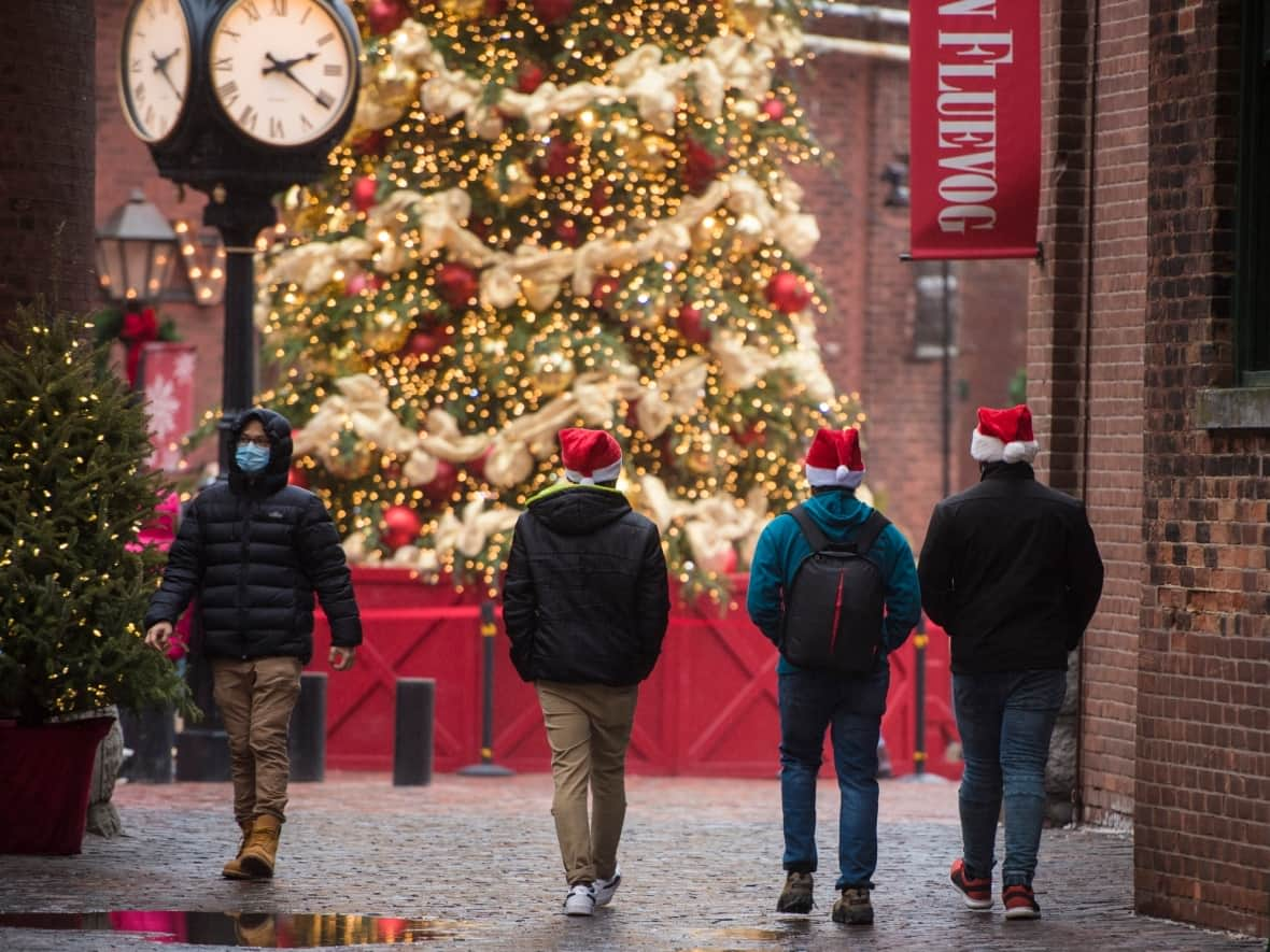 People make their way through the Distillery District in Toronto on Christmas Eve, Thursday, Dec. 24, 2020. (Tijana Martin/The Canadian Press - image credit)