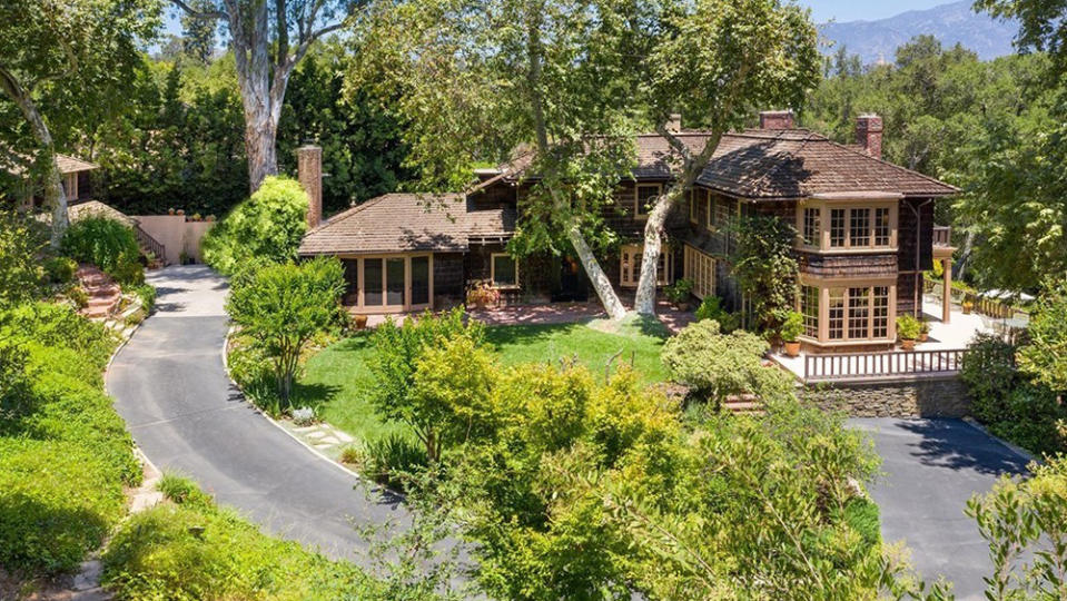 The front of the property with a winding driveway. - Credit: Redfin