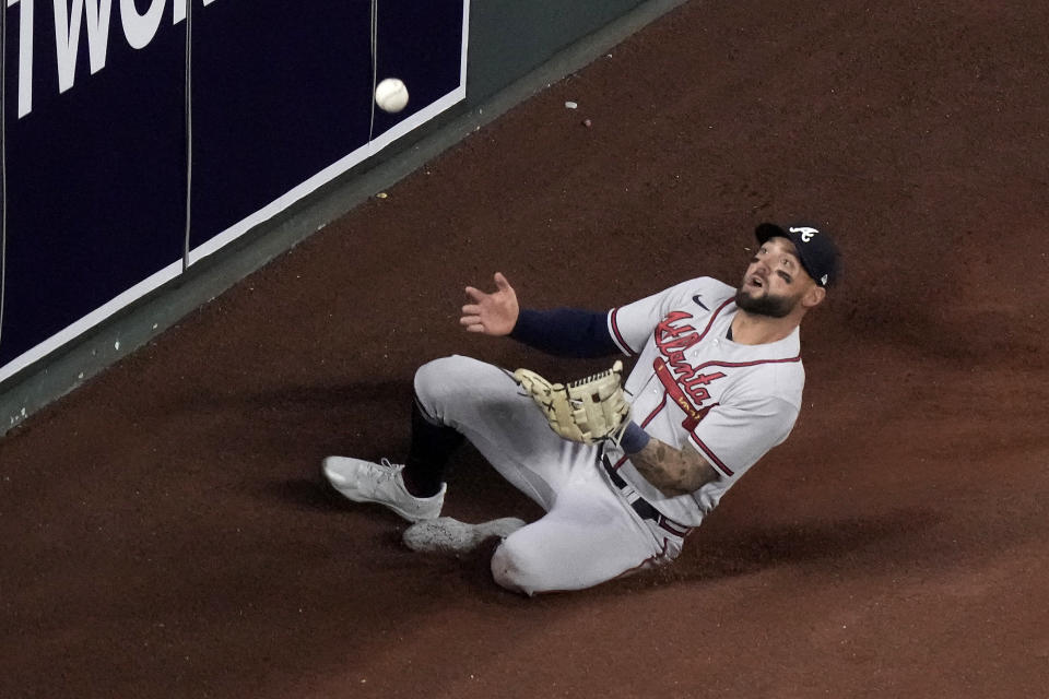 Atlanta Braves left fielder Kevin Pillar catches a sacrifice fly hit by Kansas City Royals' Michael Massey during the fourth inning of a baseball game Friday, April 14, 2023, in Kansas City, Mo. (AP Photo/Charlie Riedel)