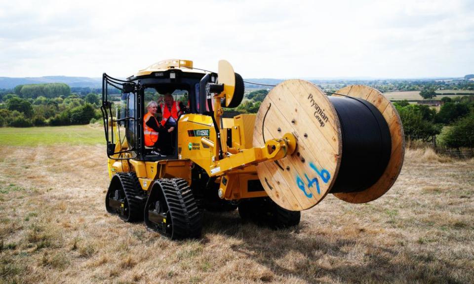 Nadine Dorries and Boris Johnson in a tractor carrying a cable reel
