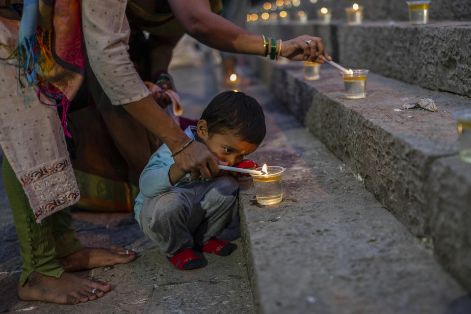 FILE - A Hindu boy lights an oil lamp at the Banganga pond as they celebrate Dev Diwali festival in Mumbai, India, Nov. 7, 2022. Diwali is the most important festival of the year in India and for Hindus in particular. It is celebrated across faiths by more than a billion people in the world’s most populous nation and the diaspora. This year, Diwali begins Friday, Nov. 10, 2023, and the festival will be observed on Sunday, Nov. 12. (AP Photo/Rafiq Maqbool, File)