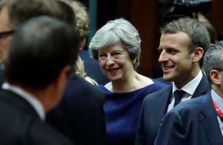 British Prime Minister Theresa May (L) and French President Emmanuel Macron arrive at a EU summit in Brussels, Belgium October 19, 2017. REUTERS/Yves Herman