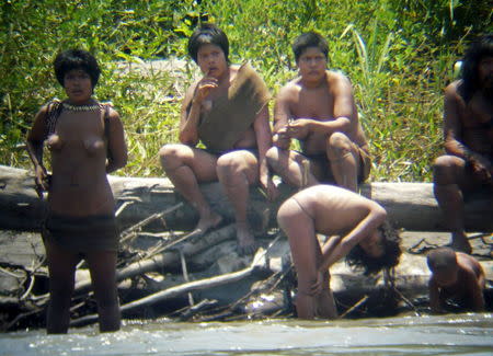 Members of the Mashco Piro tribe observe a group of travelers from across the Alto Madre de Dios river in the Manu National Park in the Amazon basin of southeastern Peru, as photographed through a bird scope in this file picture from October 21, 2011. REUTERS/Jean-Paul Van Belle/Files