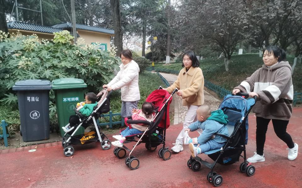 hree parents push strollers in Wenfeng Park in Fuyang City, Anhui Province, Nov 29, 2021 - Future Publishing 