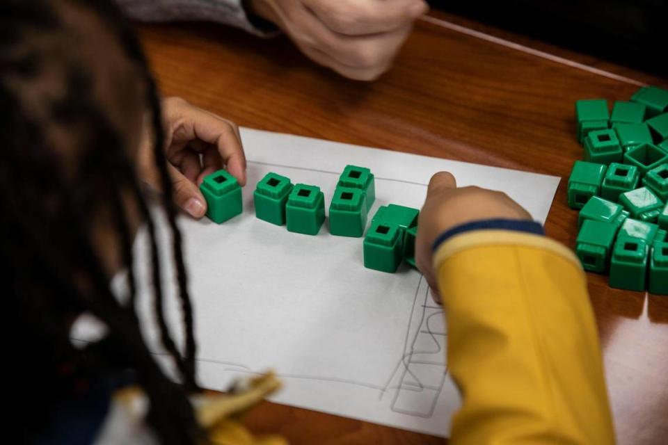 A student at Lansdowne Elementary calculates how many students are on a bus with blocks in a Heart Math tutoring session on Wednesday, Nov. 9, in Charlotte, NC. State Superintendent Catherine Truitt wants to “reform” how math is taught in North Carolina public schools.
