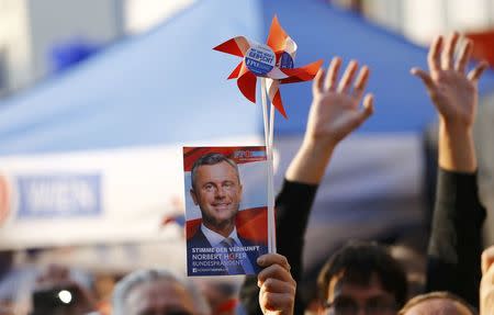 REFILE - INCLUDING TRANSLATION A supporter holds a picture of Austrian far right Freedom Party (FPOe) presidential candidate Norbert Hofer during his final election rally in Vienna, Austria, May 20, 2016. The words on picture reads "The voice of reason". REUTERS/Leonhard Foeger