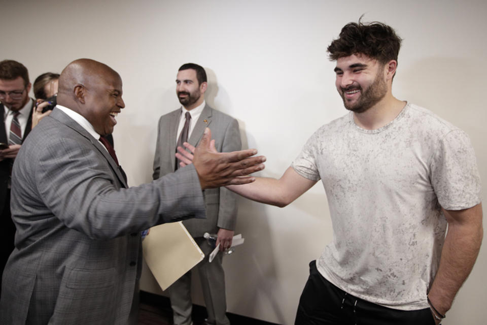 FILE - Eric Bieniemy, left, greets Washington Commanders quarterback Sam Howell, right, after being introduced as the new offensive coordinator and assistant head coach of the Commanders during an NFL football press conference in Ashburn, Va., Thursday, Feb. 23, 2023. The Commanders have a new ownership group led by Josh Harris, a new starting quarterback in Sam Howell and a new offensive coordinator in Eric Bieniemy. The buzz has led to their season opener being sold out with home fans expected to make up the vast majority of the crowd.(AP Photo/Luis M. Alvarez, File)