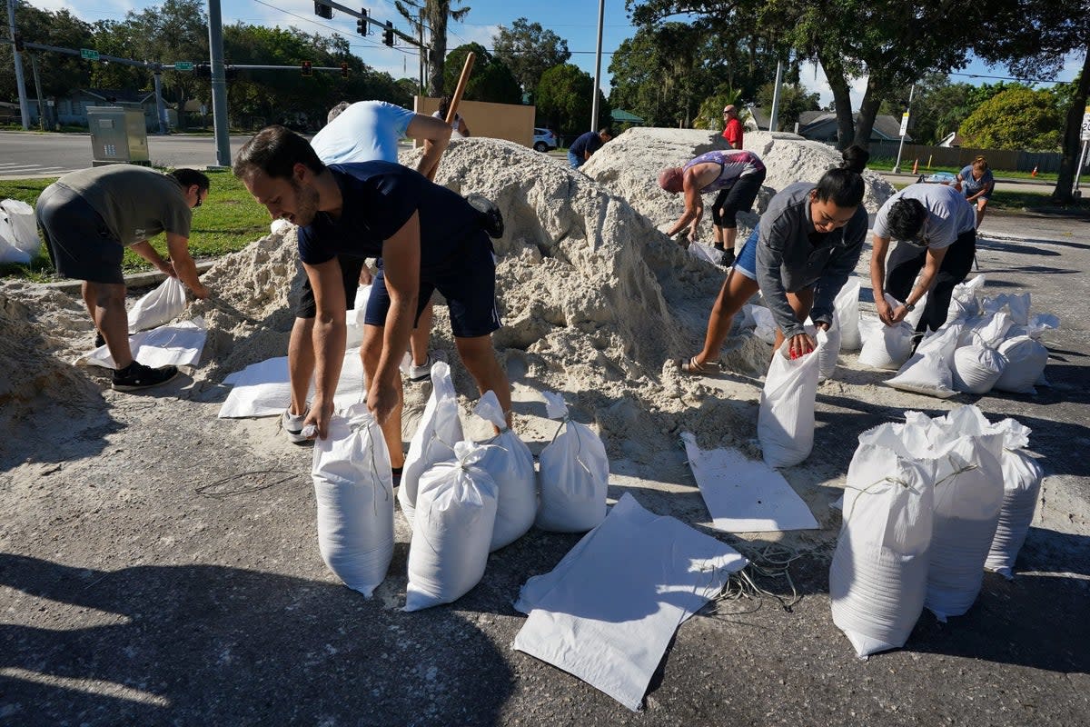 Local residents fill sandbags at a self-serve station in Bradenton, Florida (via REUTERS)