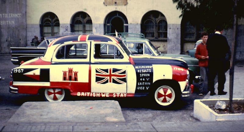 A 1967 photo of a car painted all over with Gibraltarian and British flags - Credit: Andy Newton
