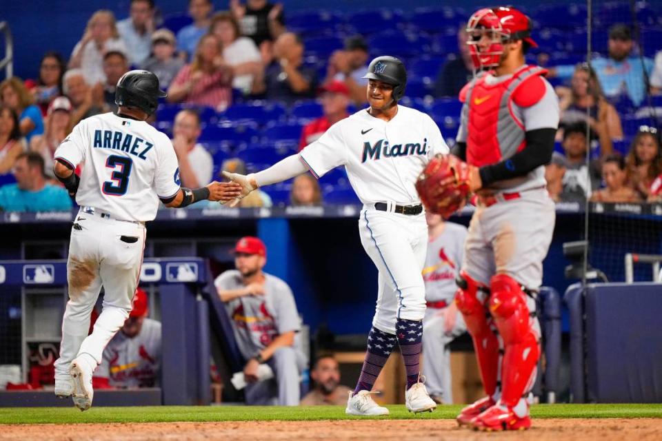 Miami Marlins second baseman Luis Arraez (3) and Miami Marlins outfielder Dane Myers (54) celebrate scoring against the St. Louis Cardinals during the seventh inning at loanDepot Park.