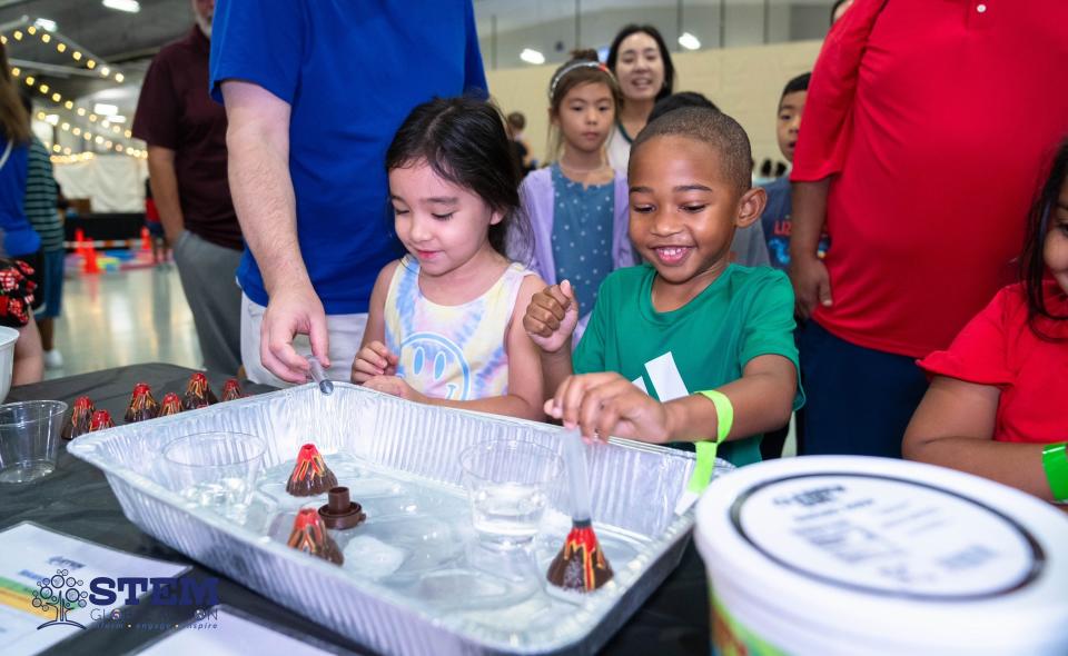Kids perform a volcano experiment Sept. 2 at STEM Fest in Montgomery.