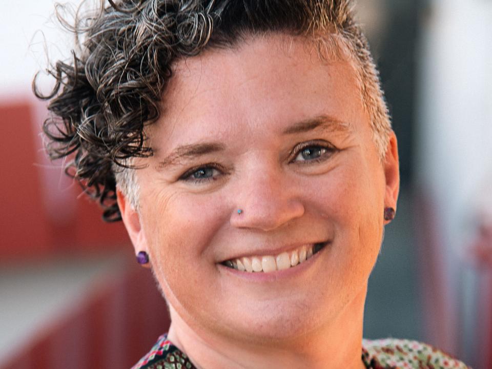 A woman smiles at the camera for a headshot.