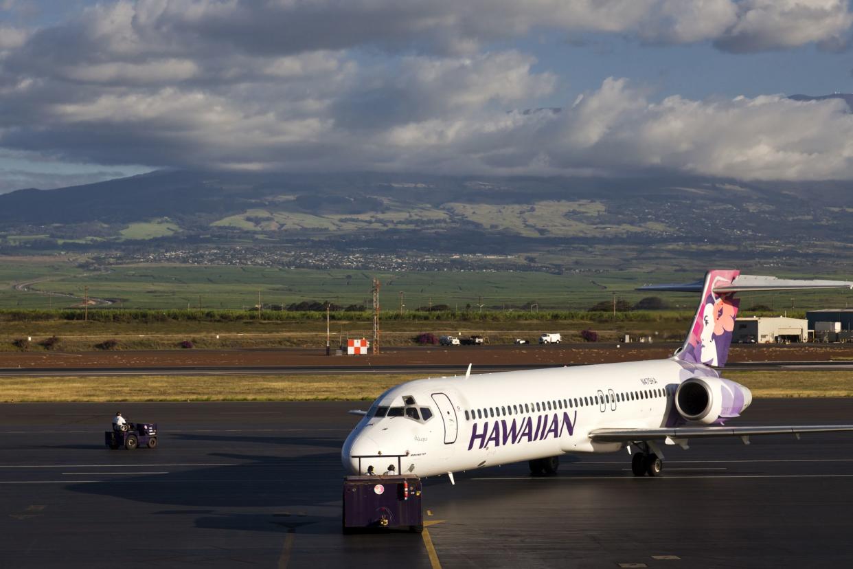 Kahului Maui, Hawaii, USA - February, 8th 2010: Hawaiian Airlines Boeing 717 Jet Airliner in Maui leaving the passenger terminal.