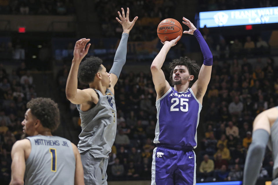 Kansas State forward Ismael Massoud (25) shoots over West Virginia forward Tre Mitchell (3) during the first half of an NCAA college basketball game on Saturday, March 4, 2023, in Morgantown, W.Va. (AP Photo/Kathleen Batten)