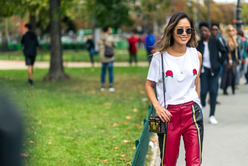 La Fashion Week est le moment idéal pour faire la promotion de sa ligne de vêtements, et la superblogueuse Aimee Song l'a bien compris. On la voit ici avec son T-shirt Two Songs orné de roses (une partie des recettes est reversée afin de lutter contre le cancer du sein).