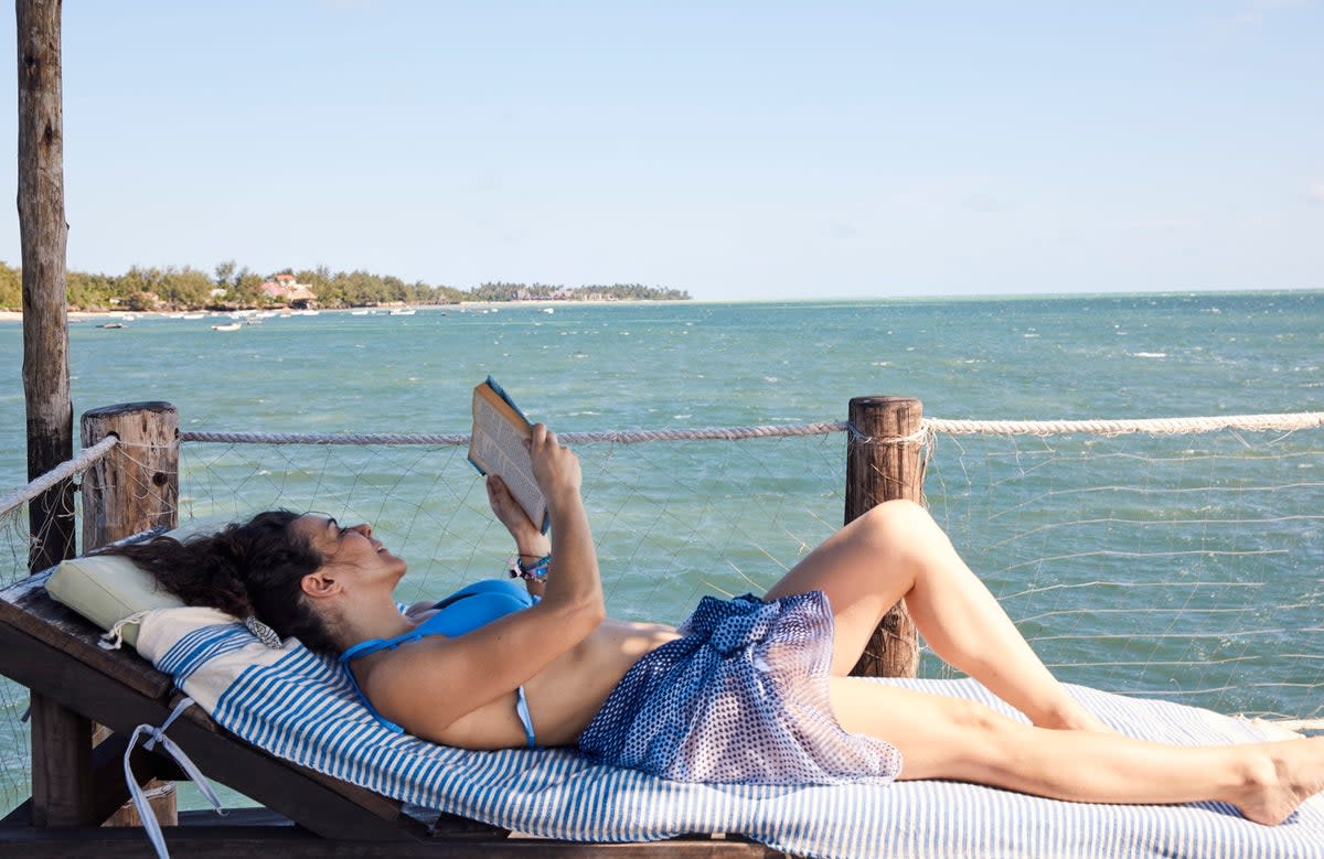 Many people said are more confident about their book choices when on holiday, reading subject matter they’d be too embarrassed to when at home (SWNS)