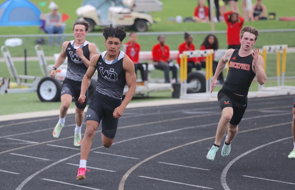 West Ottawa's Ruben Esparza (center) runs the 200 meters at the OK Red Championships on Friday, May 12, 2023, at Hudsoville.