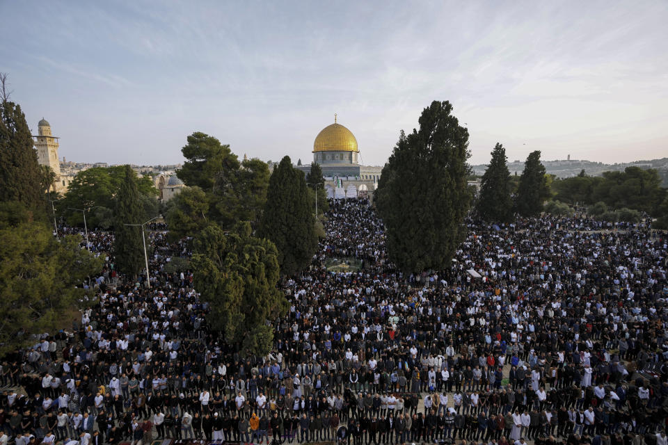 Muslims take part in Eid al-Fitr prayers next to the Dome of the Rock Mosque in the Al-Aqsa Mosque compound in the Old City of Jerusalem, Monday, May 2, 2022. Eid al-Fitr, festival of breaking of the fast, marks the end of the holy month of Ramadan. (AP Photo/Mahmoud Illean)