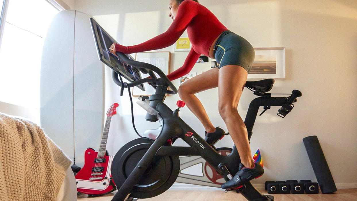  Woman riding a Peloton Bike+ . 