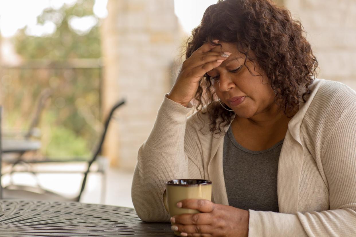 Middle age woman in deep thought dealing with depression.