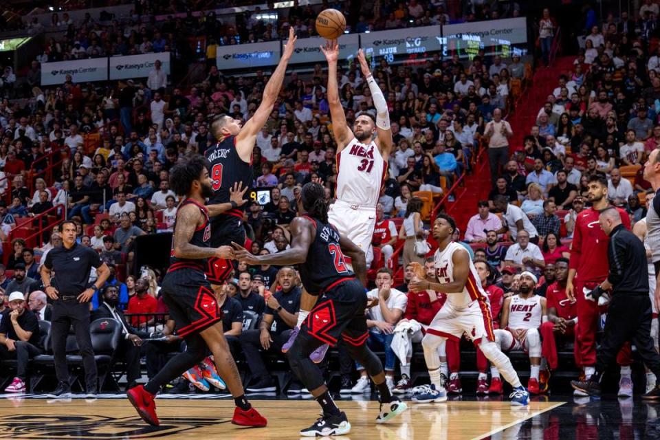Miami Heat forward Max Strus(31) shoots a three-pointer over Chicago Bulls center Nikola Vucevic (9) during the fourth quarter of an NBA play-in tournament game at Kaseya Center in Downtown Miami, Florida, on Friday, April 14, 2023.