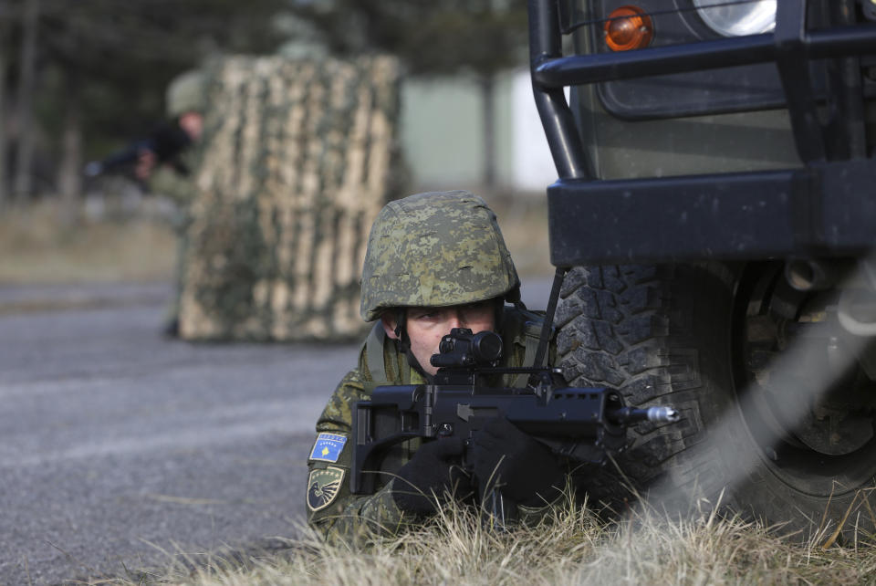 Member of Kosovo's Security Forces takes part in a exercise in southeastern town of Gjilan, Kosovo on Thursday, Dec. 13, 2018, a day before the parliament votes to transform them into a regular army. Kosovo lawmakers are set to transform the Kosovo Security Force into a regular army, a move that significantly heightened tension with neighboring Serbia which even left open a possibility of an armed intervention in its former province. (AP Photo/Visar Kryeziu)