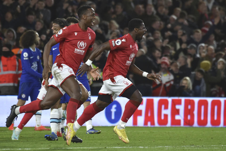 Nottingham Forest's Serge Aurier, right, celebrates after scoring his side's opening goal during the English Premier League soccer match between Nottingham Forest and Chelsea at City ground in Nottingham, England, Sunday, Jan. 1, 2023. (AP Photo/Rui Vieira)