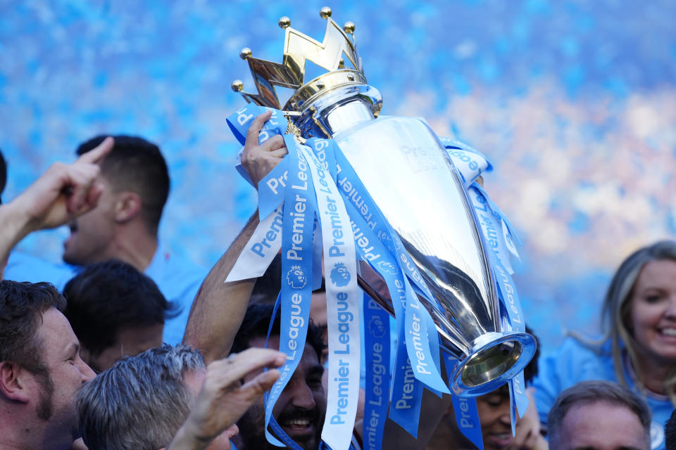 Manchester City players celebrate their Premier League title after the English Premier League soccer match between Manchester City and Chelsea at the Etihad Stadium in Manchester, England, Sunday, May 21, 2023. (AP Photo/Jon Super)