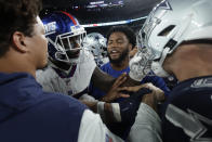 New York Giants and Dallas Cowboys players push and shove each other after an NFL football game, Monday, Sept. 26, 2022, in East Rutherford, N.J. (AP Photo/Adam Hunger)