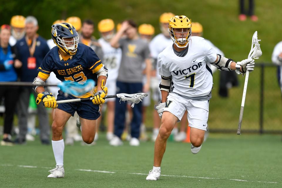 Victor's Kyle Saeger, right, is defended by West Genesee's Jack Mellen during a NYSPHSAA Boys Lacrosse Championships Class B semifinal in Cortland, N.Y., Friday, June 9, 2023. Victor advanced to the Class B final with an 20-9 win over West Genesee.