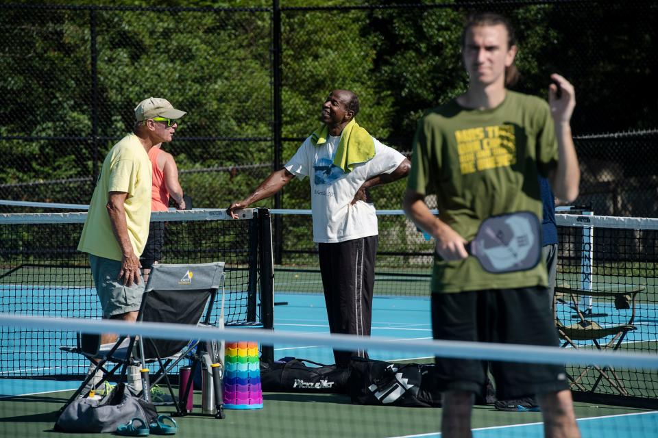 Pickleball players chat between games at Murphy-Oakley Park in Asheville June 17, 2022.