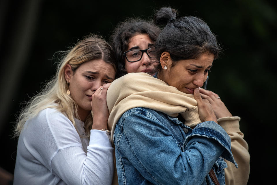 Young women weep as they hold each other for comfort during a students vigil near Al Noor mosque on March 18, 2019 in Christchurch, New Zealand. (Photo: Carl Court/Getty Images)