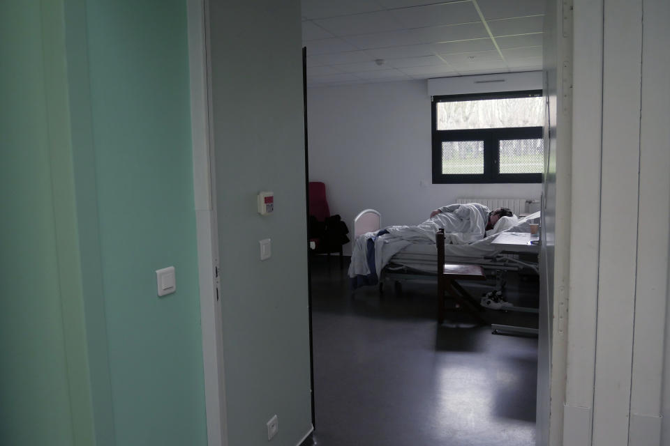 A patient sleeps in his room in the emergency ward of the Rouvray psychiatric hospital, in Rouen, western France, Wednesday, Nov. 25, 2020. Lockdowns that France has used to fight the coronavirus have come at considerable cost to mental health. Surveying points to a surge of depression most acute among people without work, in financial hardship and young adults. (AP Photo/Thibault Camus)