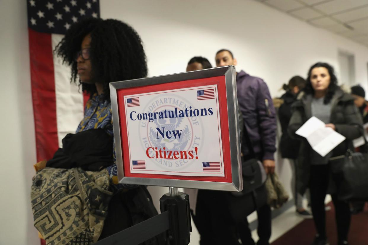 Immigrants wait in line to become US citizens at a naturalization ceremony at the US Citizenship and Immigration Services: John Moore/Getty Images