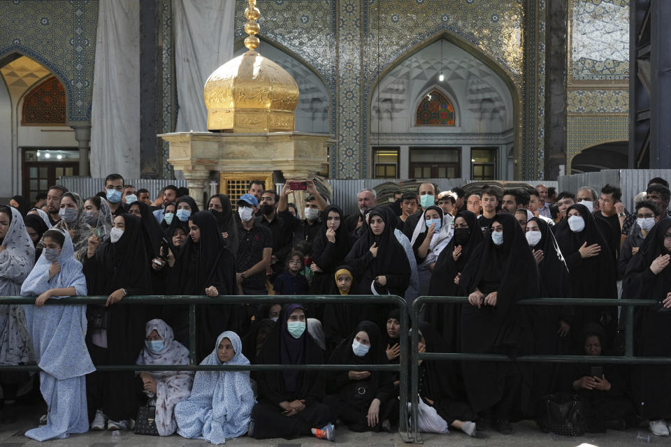 Mourners attend an annual procession commemorating Ashoura which marks the death anniversary of Imam Hussein, the grandson of Prophet Muhammad, who was killed with 72 of his companions in the 7th century in the Battle of Karbala in present-day Iraq, in Tehran, Iran, Monday, Aug. 8, 2022. (AP Photo/Vahid Salemi)