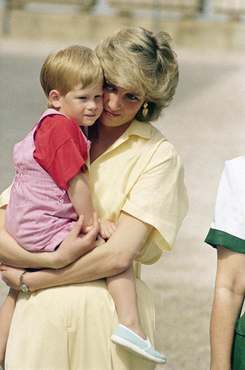 FILE - In this Sunday, Aug. 9, 1987 file photo, Diana, the Princess of Wales holds son Prince Harry while royal families posed for photographers at the Royal Palace, in Majorca, Spain. Princess Diana’s little boy, the devil-may-care red-haired prince with the charming smile is about to become a father. The arrival of the first child for Prince Harry and his wife Meghan will complete the transformation of Harry from troubled teen to family man, from source of concern to source of national pride. (AP Photo/John Redman, File)