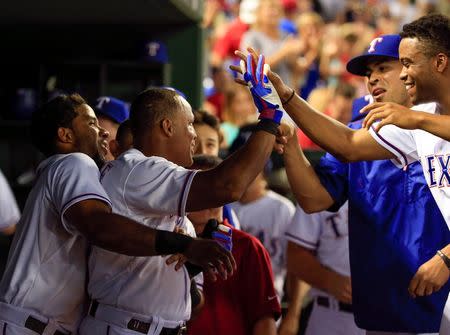 Aug 3, 2015; Arlington, TX, USA; Texas Rangers third baseman Adrian Beltre (29) celebrates with teammates after hitting a home run to complete the cycle during the fifth inning against the Houston Astros at Globe Life Park in Arlington. Mandatory Credit: Kevin Jairaj-USA TODAY Sports