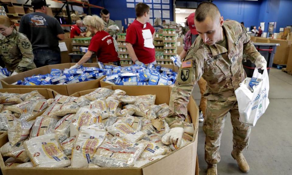 Arizona national guard members pack and sort food items at a food bank in Mesa, Arizona.