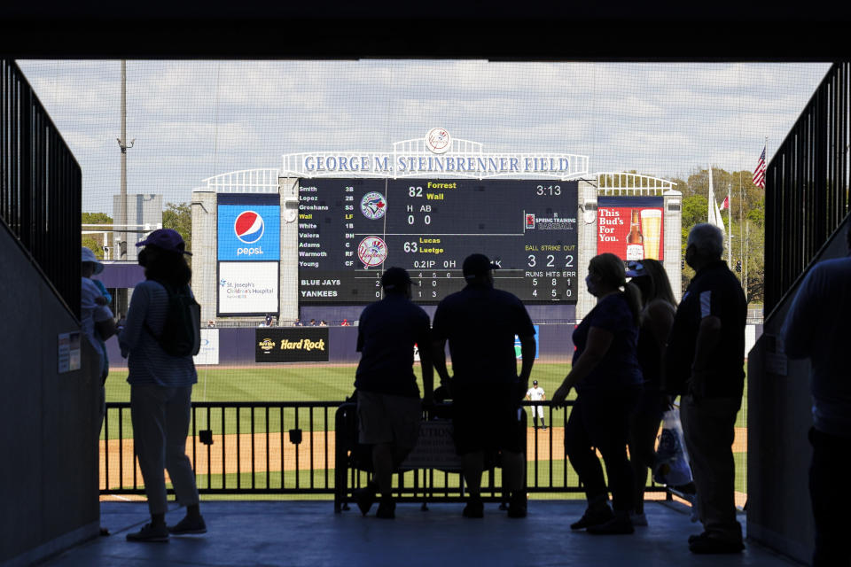 Fans walk along the Mezzanine during the sixth inning of a spring baseball game between the New York Yankees and the Toronto Blue Jays at George M. Steinbrenner Field Sunday, Feb. 28, 2021, in Tampa, Fla. (AP Photo/Frank Franklin II)