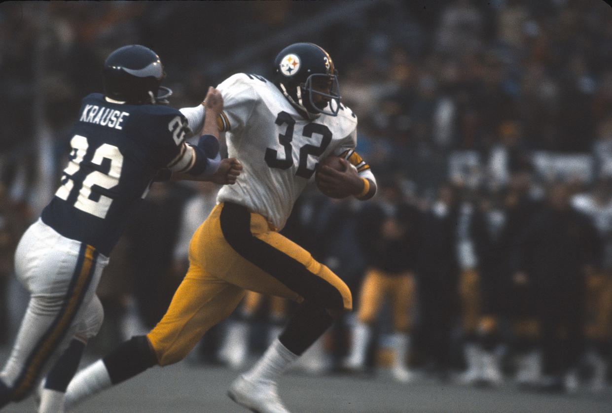 Franco Harris #32 of the Pittsburgh Steelers carries the ball pursued by Paul Krause #32 of the Minnesota Vikings during Super Bowl IX