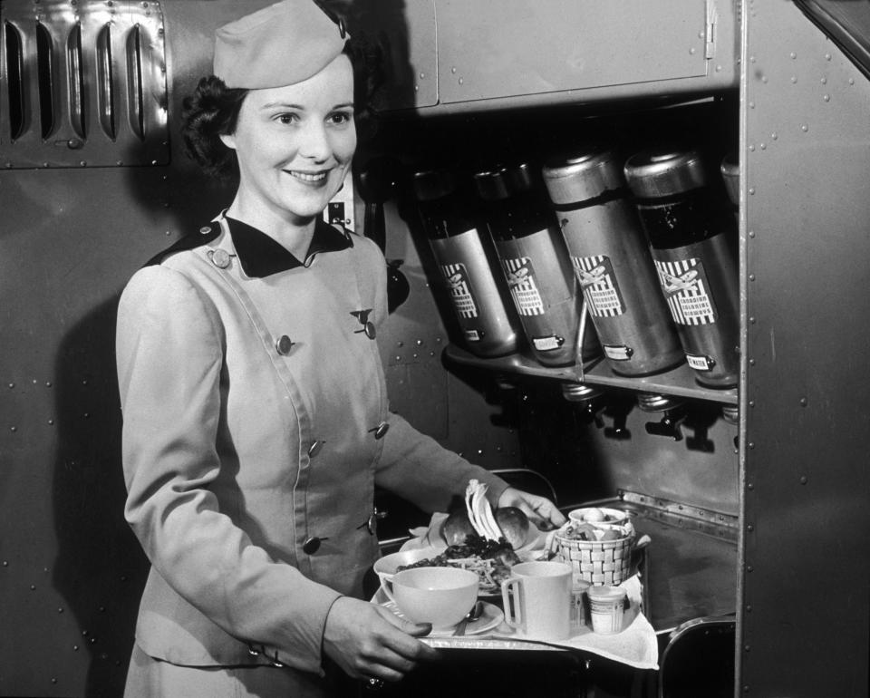 A Canadian Colonial Airways flight attendant&nbsp;with a tray of food and refreshments in the 1940s.