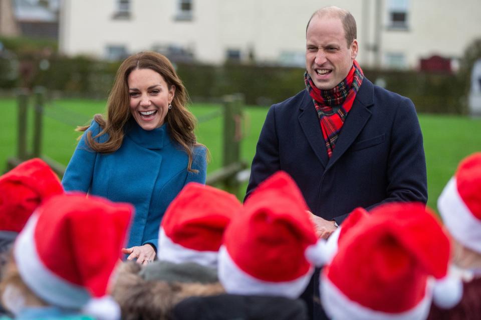 Britain's Prince William, Duke of Cambridge (R) and Britain's Catherine, Duchess of Cambridge (L) meet schoolchildren 