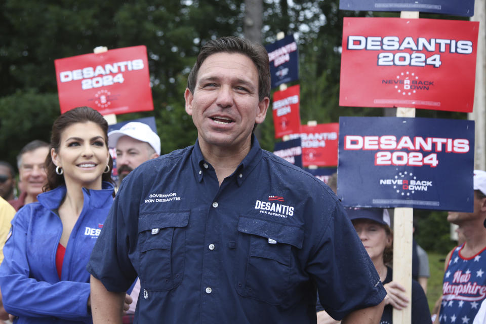 FILE - Republican presidential candidate and Florida Gov. Ron DeSantis and his wife Casey, walk in the July 4th parade, July 4, 2023, in Merrimack, N.H. On Friday, July 14, The Associated Press reported on stories circulating online incorrectly claiming a quote below Florida Gov. Ron DeSantis’ high school yearbook photo reads: “My Mount Rushmore is Jesus, Sir-Mixes-a-Lot, and Nintendo 64.” (AP Photo/Reba Saldanha, File)